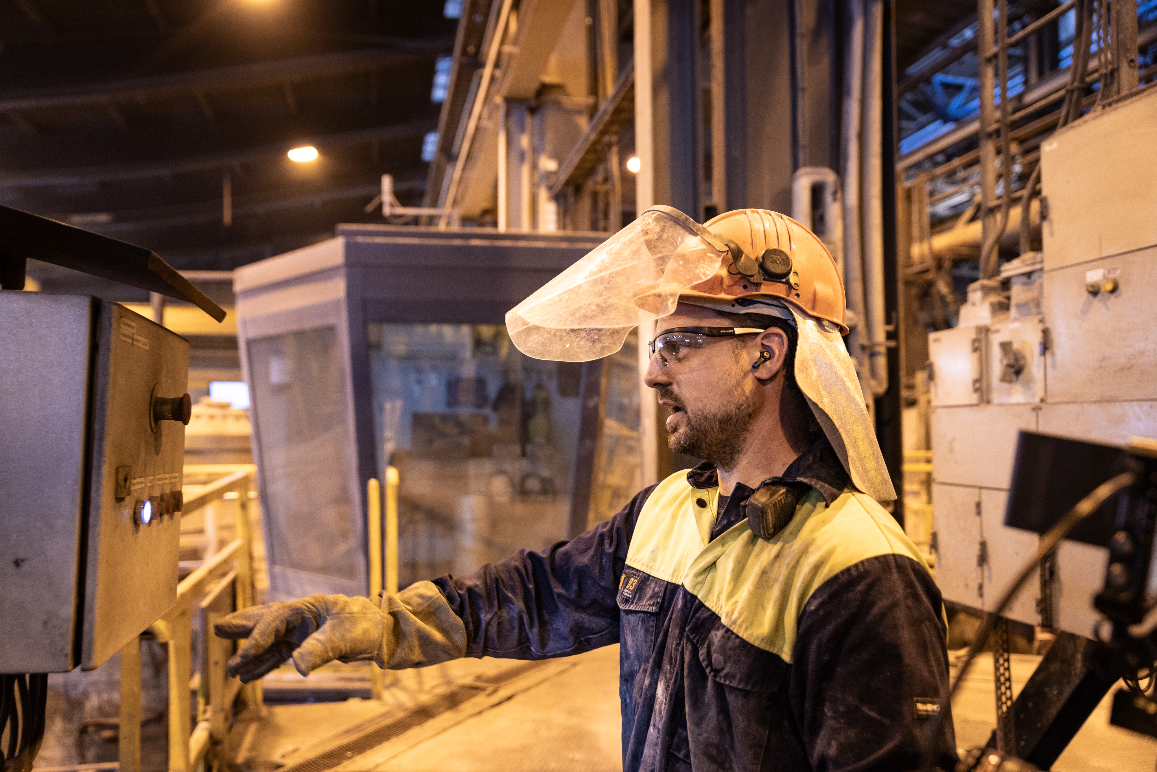 Oskar Rundberg, operator at Stena Aluiminium’s smelter, dressed in hi-vis protective gear, standing in the smelter, shows the process of recycling aluminium.