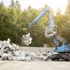 A Stena Metall Group crane at work lifting scrap material for recycling.