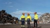 Three Stena Metall employees in hi-vis working gear are standing outside a recycling facility, where metal scrap is treated and recycled