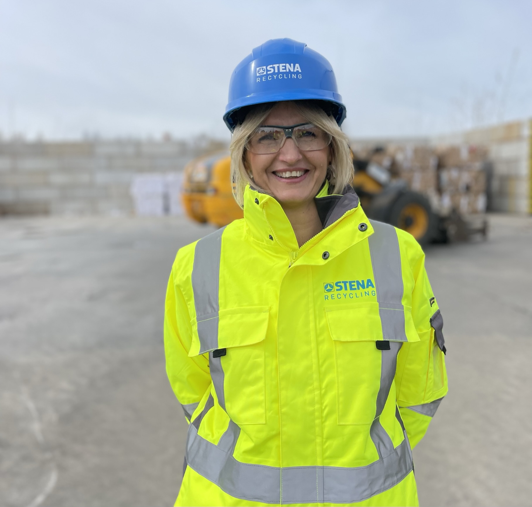 Iwona Korniluk, branch manager at a recycling facility, dressed in hi-vis protective gear, standing outside, talking about how they have managed to avoid accidents in 12 years.